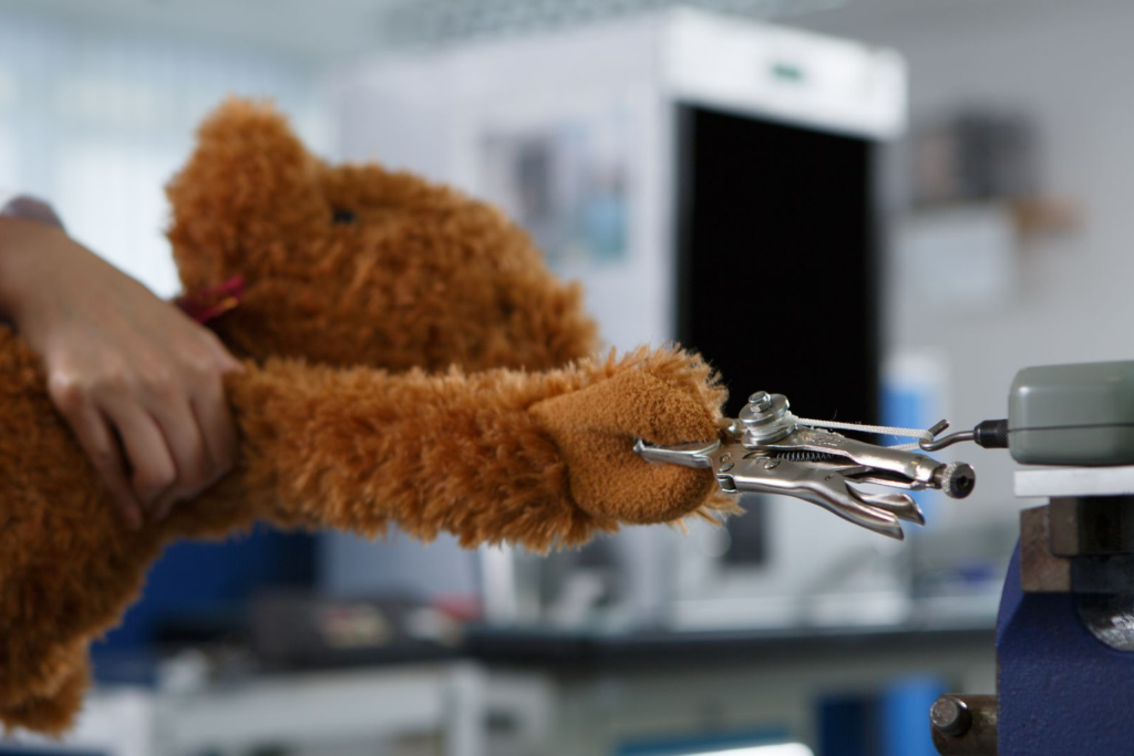Custom plush toy seam tensile strength test during stuffed animal safety and quality inspection